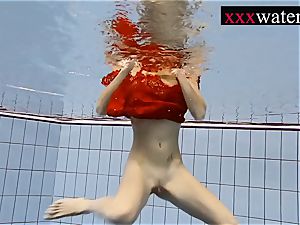 sumptuous red-hot gal swimming in the pool